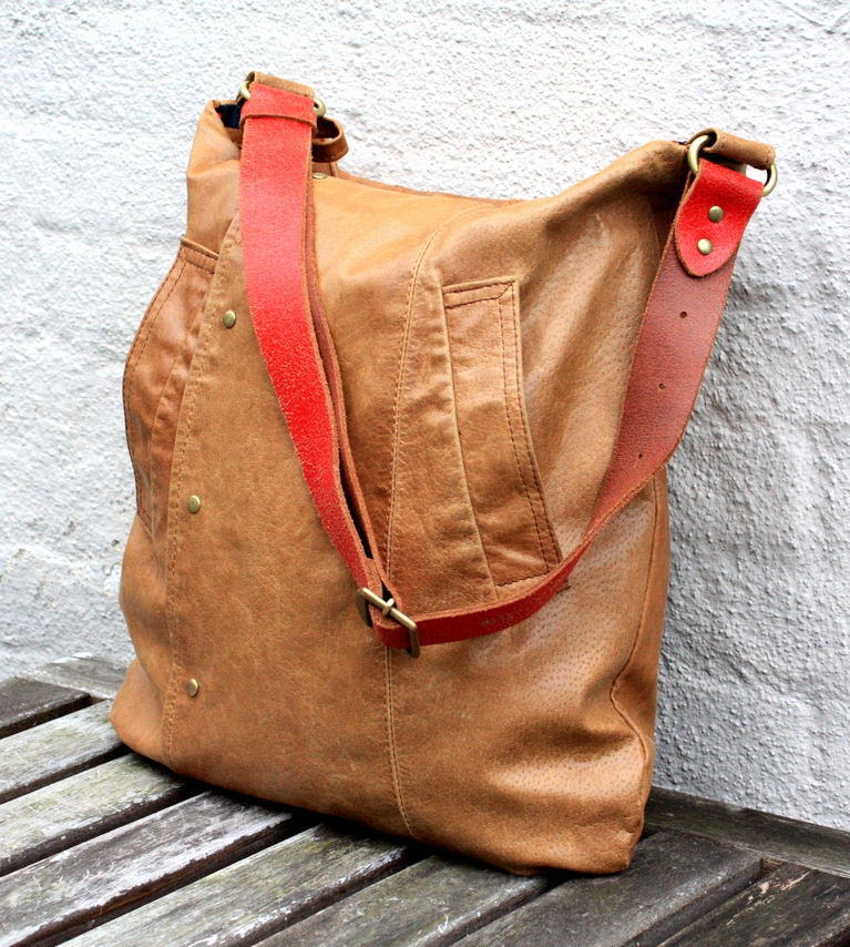 Cognac brown leather bag with a red strap