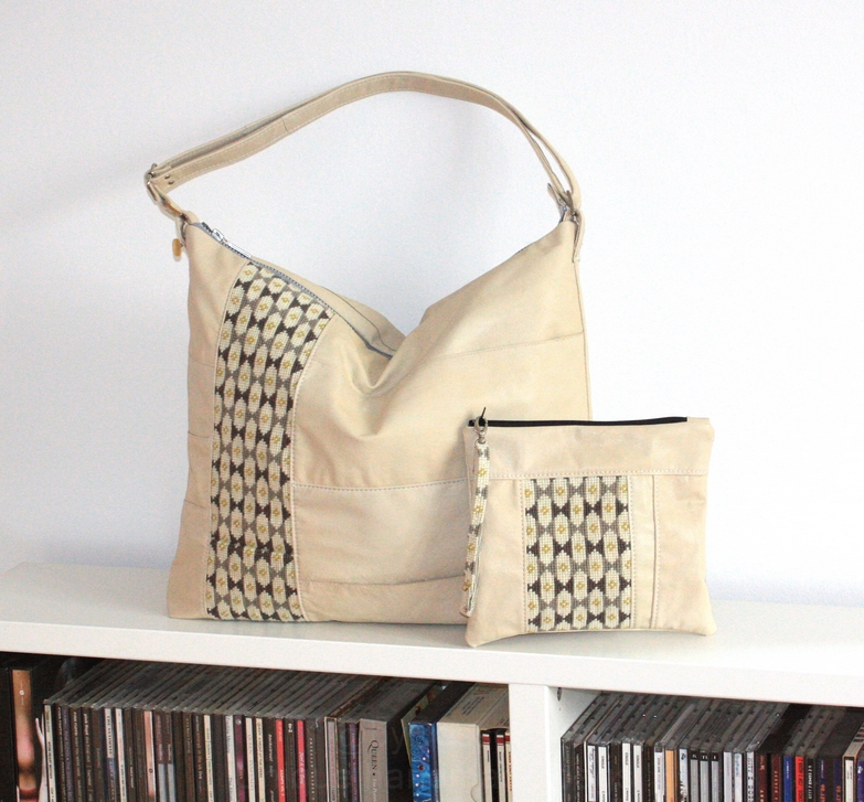 A beige leather bag with embroidery